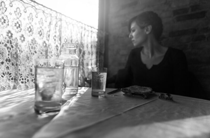 Lady in Restaurant Thinking Free Stock Photo